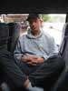 Pete cross-legged... sleeping in a minibus